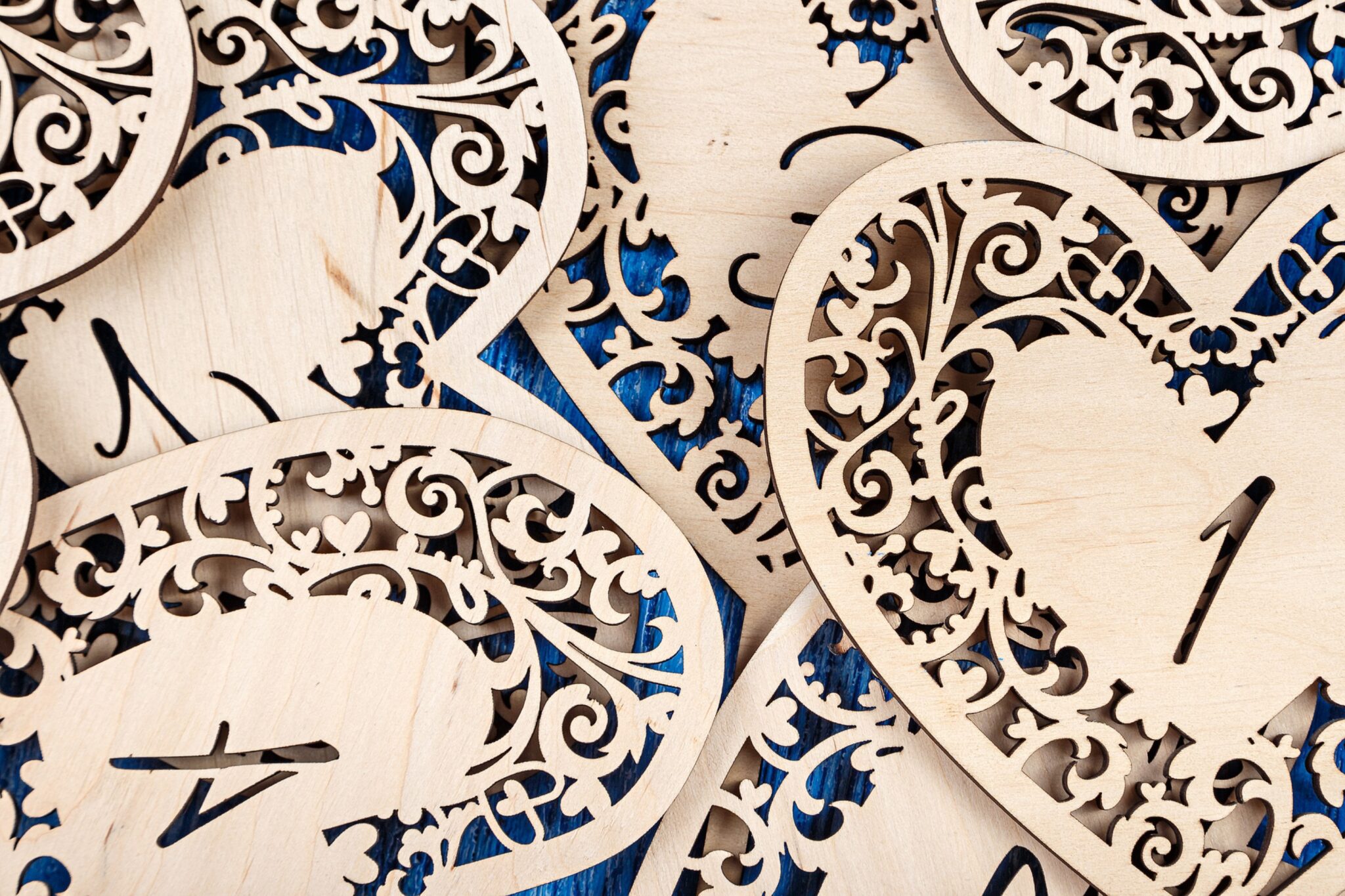 Intricate wooden heart-shaped cutouts with numbers.
